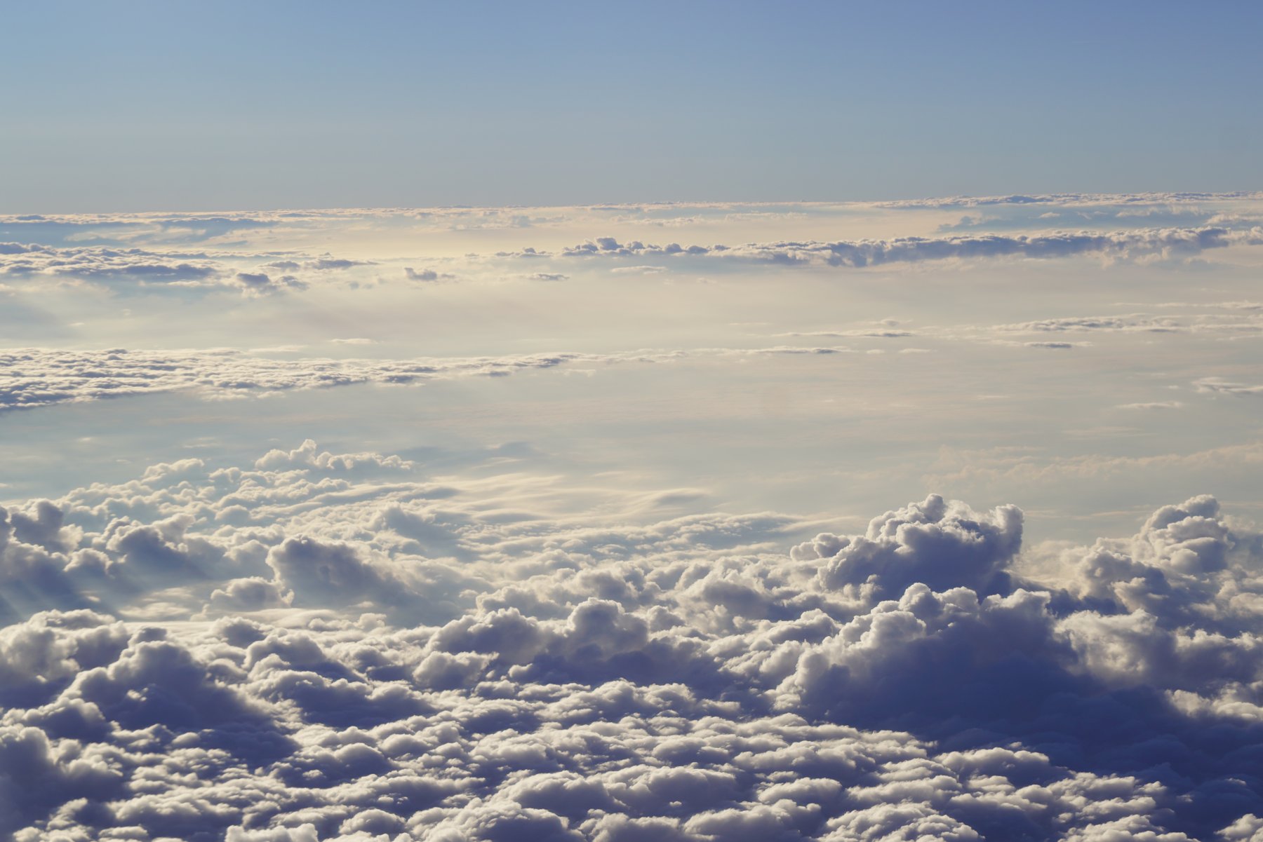 View above the clouds from an airplane window