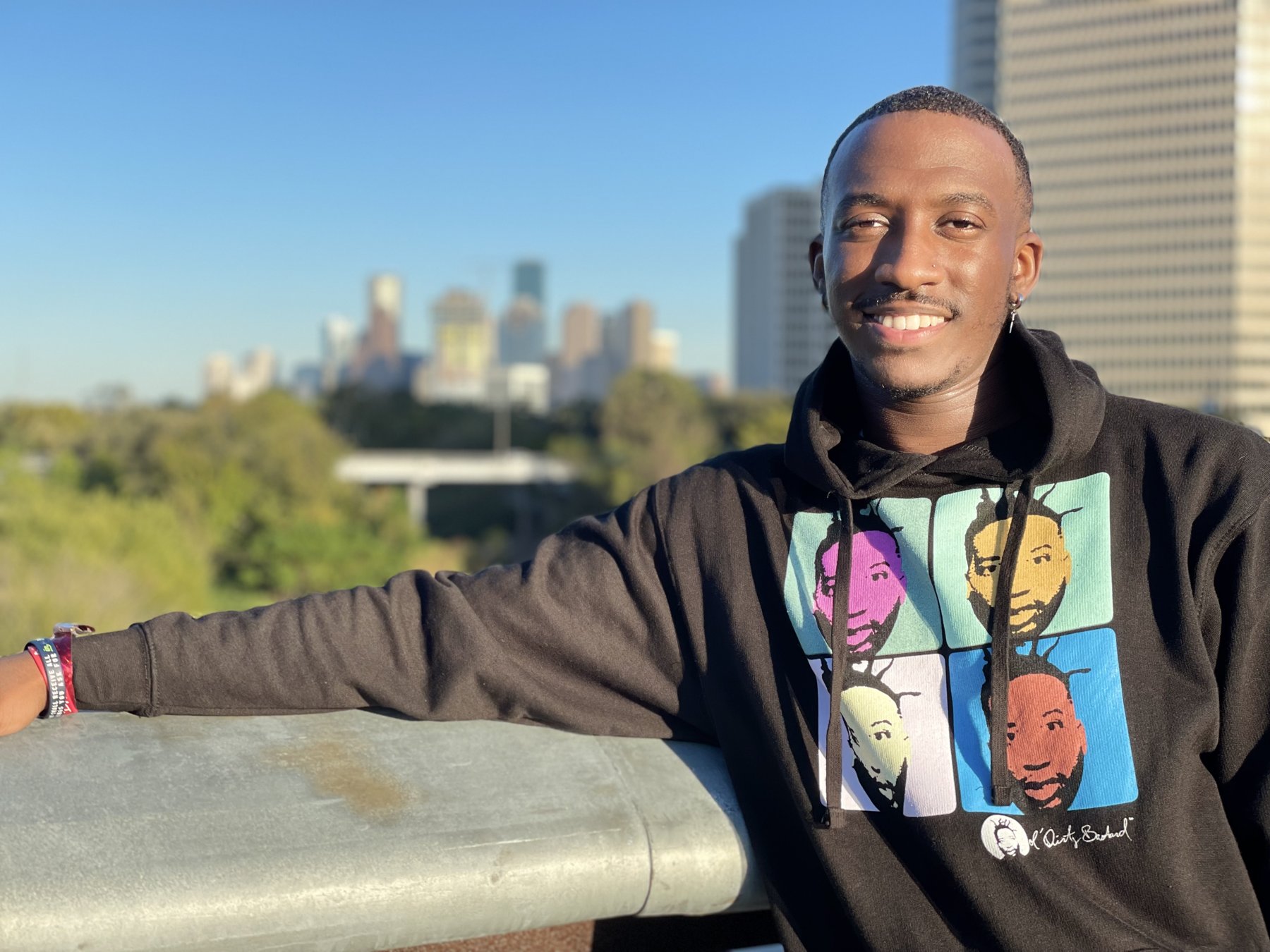 Victor Griffin on a rooftop overlooking a city skyline